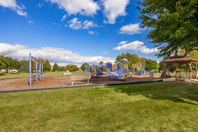 a view of a park with swings and slides