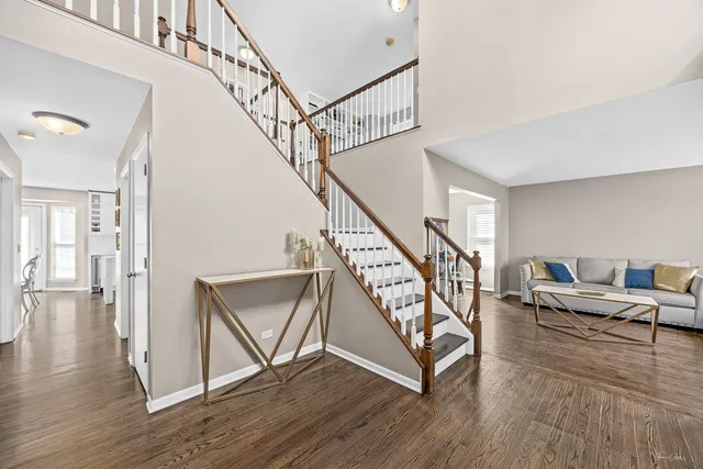 a view of entryway and hall with wooden floor