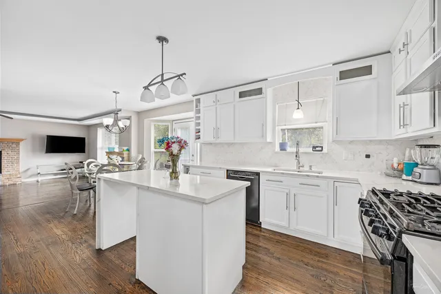 a kitchen with sink cabinets and wooden floor