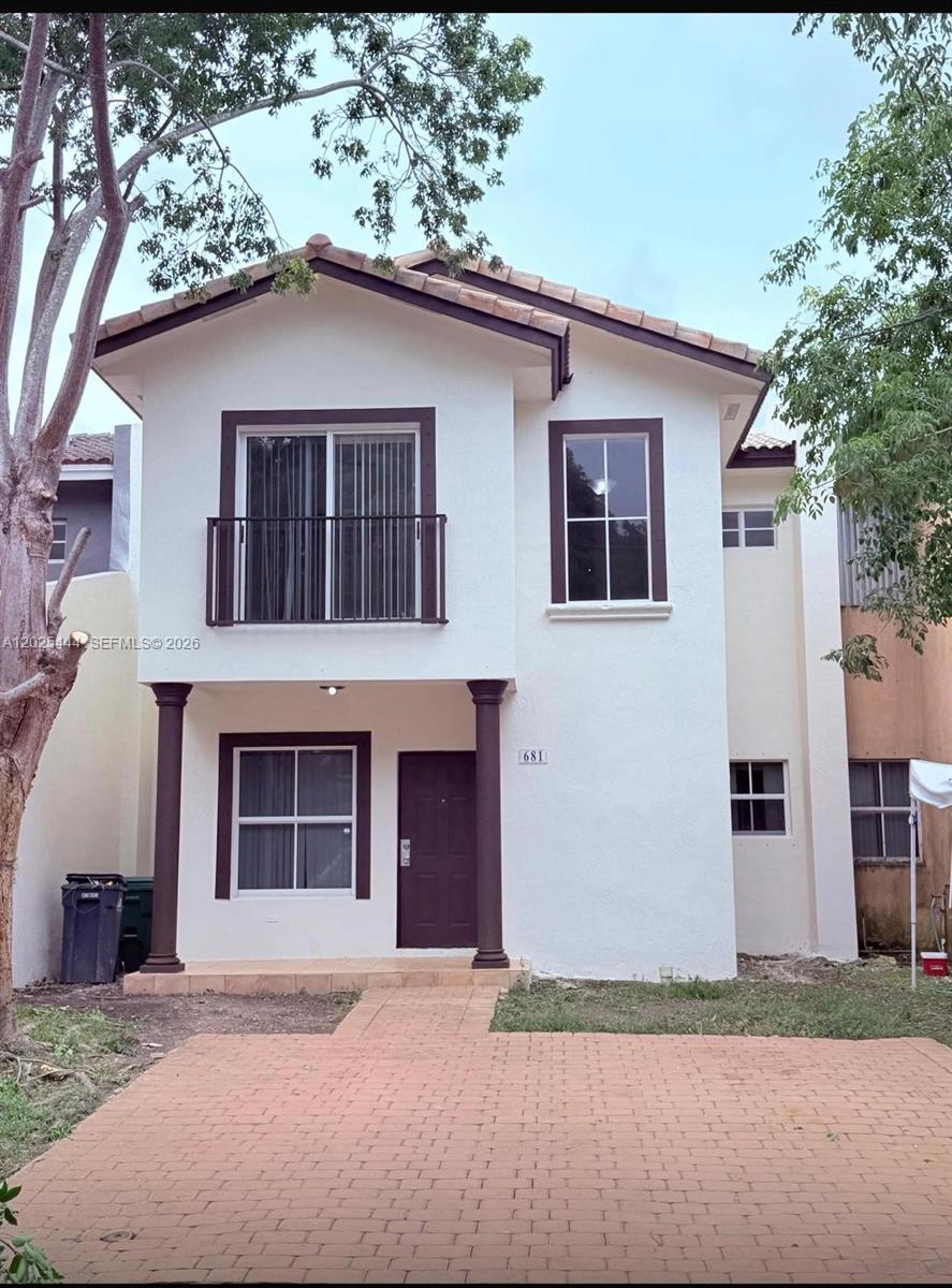 681 Southwest 7th Street, Unit 681 Florida City, FL 33034 - Photo 1 of 16 a front view of a house with a yard and garage