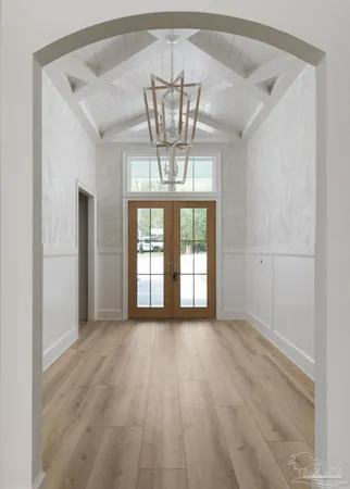 a view of empty room with a window and chandelier