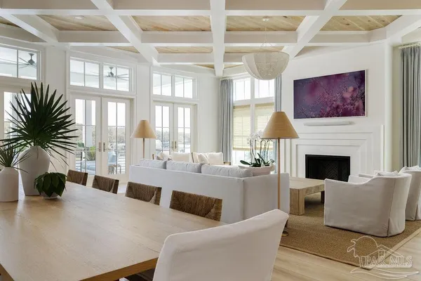 a living room with furniture fireplace and a large window