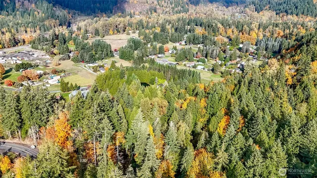 a view of a houses with a lush green hillside