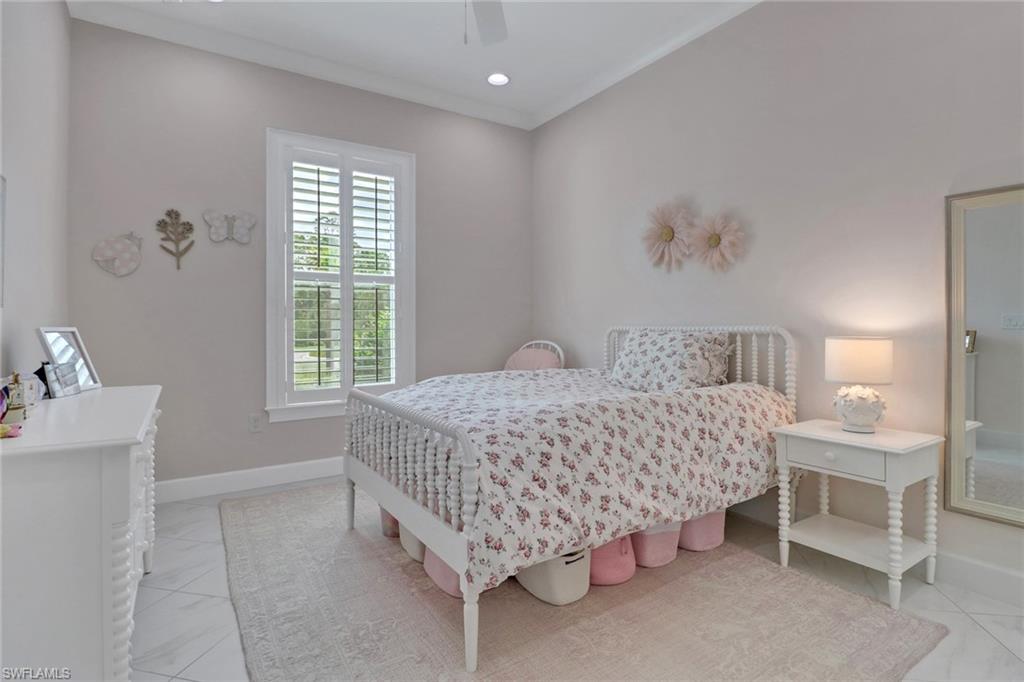 6509 Dominica Drive, Unit 101 Naples, FL 34113 - Photo 17 of 33 a bedroom with a bed and a table in it