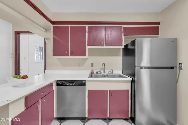 a bathroom with a black white checkered floor and a window