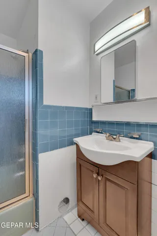 an aerial view of a city with lots of residential buildings and ocean view