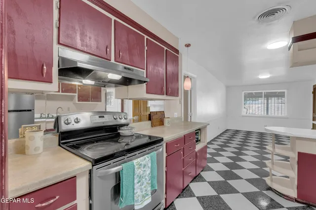a kitchen with stainless steel appliances granite countertop a stove and cabinets