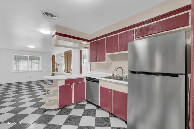 a kitchen with granite countertop a stove a sink and a microwave