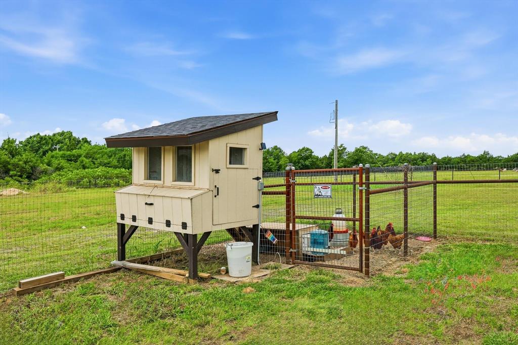 6020 Honeysuckle Road Midlothian, TX 76065 - Photo 32 of 39 Elevated chicken coop featuring a shingled roof and multiple windows