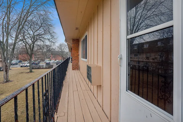 a view of a balcony with wooden floor