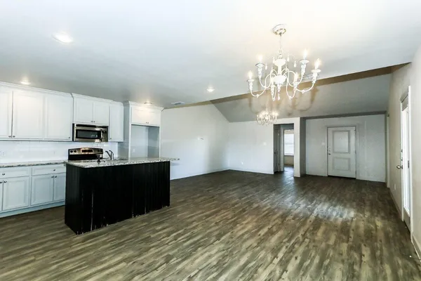 a view of a kitchen with microwave and cabinets