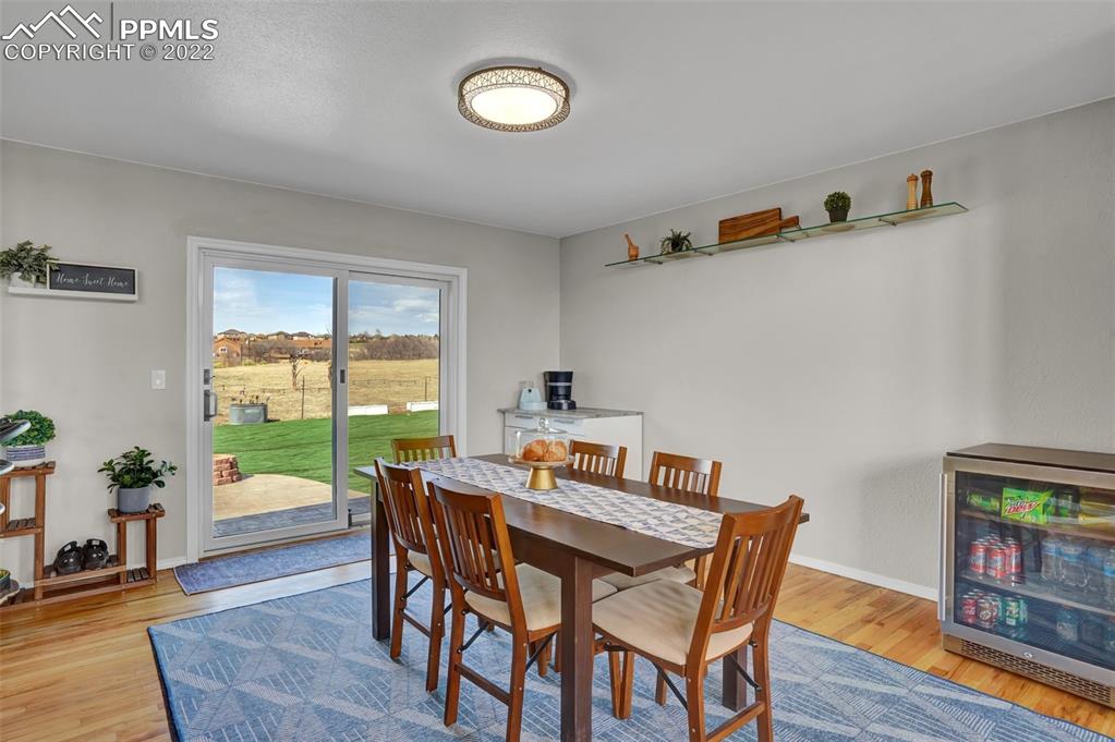545 Struthers Loop Colorado Springs, CO 80921 - Photo 16 of 44 a view of a dining room with furniture window and wooden floor