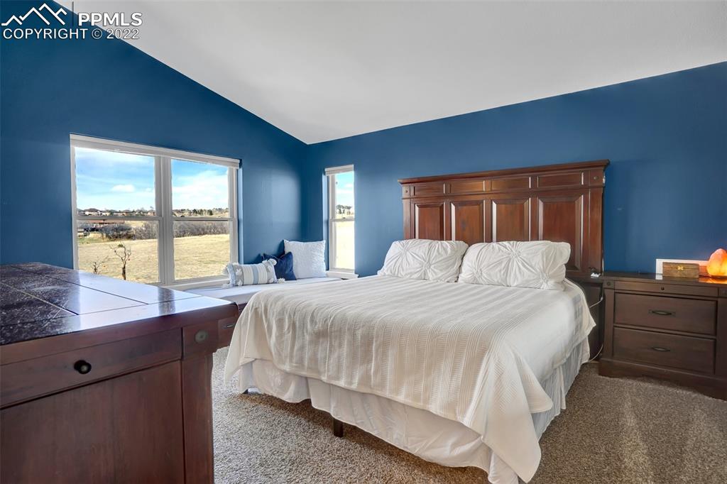 545 Struthers Loop Colorado Springs, CO 80921 - Photo 23 of 44 a bedroom with a large bed and large window