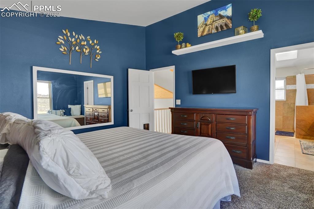 545 Struthers Loop Colorado Springs, CO 80921 - Photo 25 of 44 a bedroom with a bed and a flat screen tv