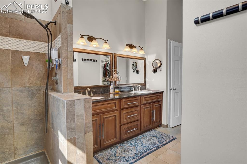 545 Struthers Loop Colorado Springs, CO 80921 - Photo 28 of 44 a bathroom with a sink and a mirror