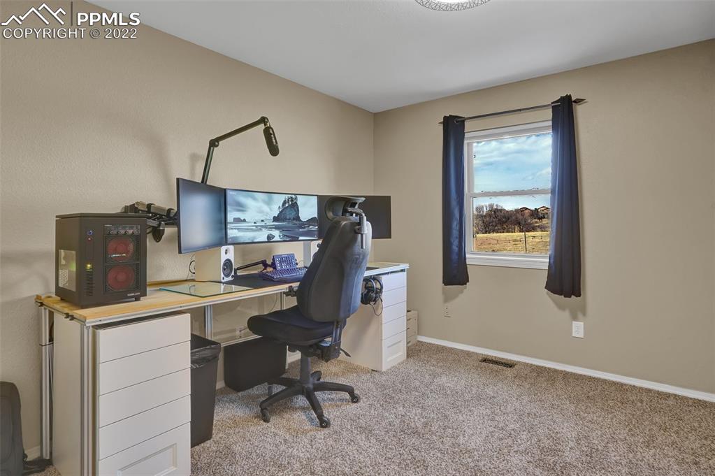545 Struthers Loop Colorado Springs, CO 80921 - Photo 33 of 44 a view of a workspace with furniture and a window