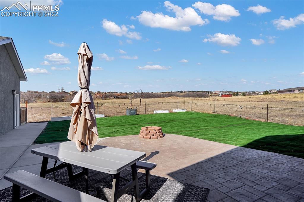 545 Struthers Loop Colorado Springs, CO 80921 - Photo 43 of 44 a view of a patio with a table and chairs
