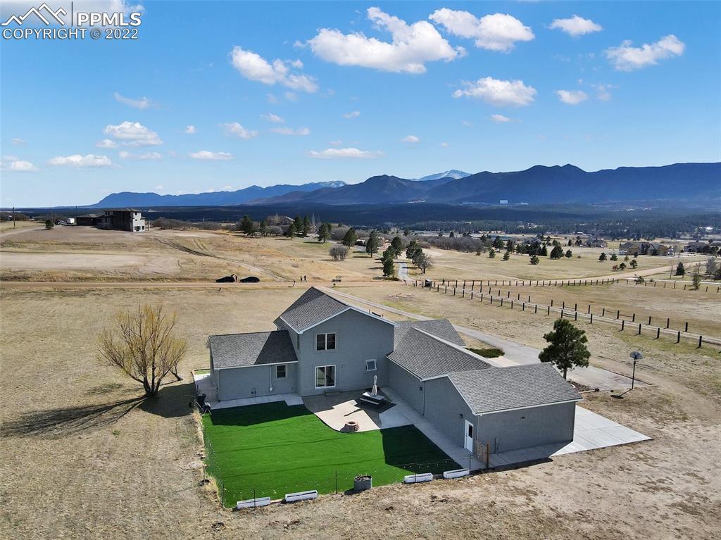 545 Struthers Loop Colorado Springs, CO 80921 - Photo 7 of 44 a view of a house with a garden and a mountain