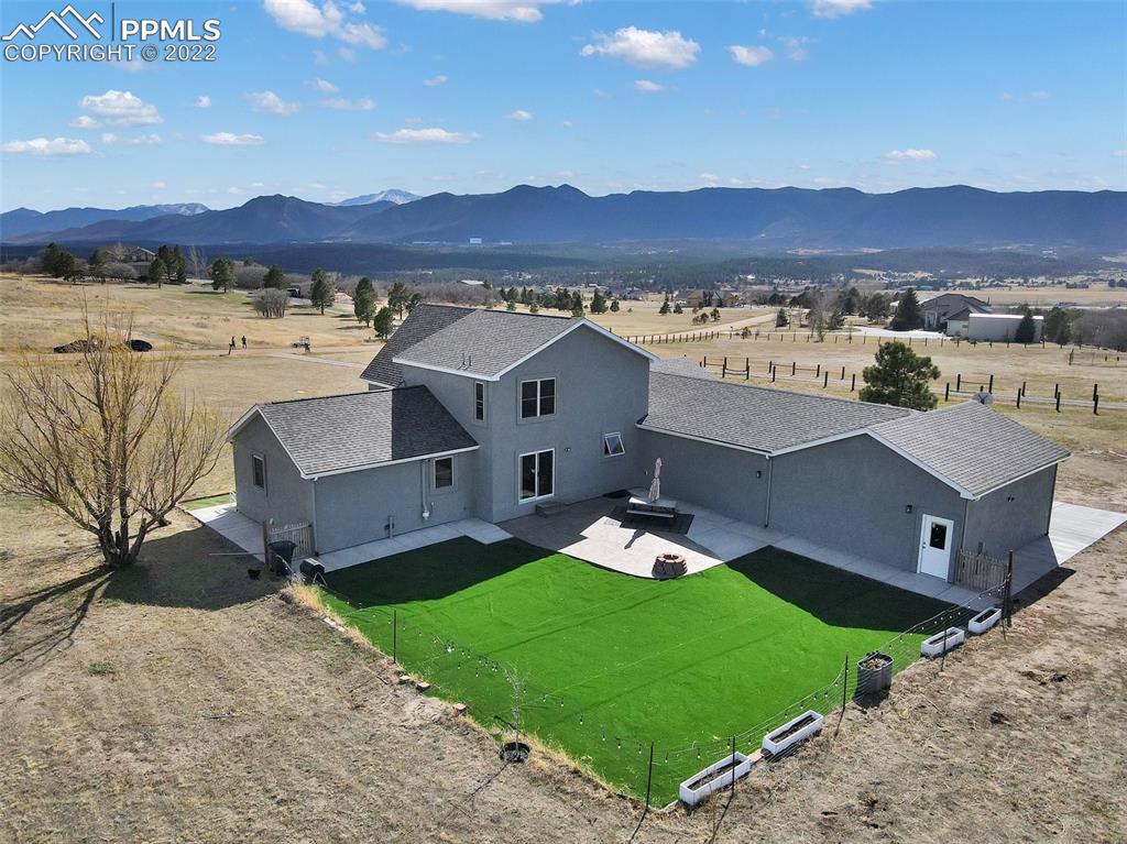 545 Struthers Loop Colorado Springs, CO 80921 - Photo 8 of 44 a view of a house with a yard and a mountain