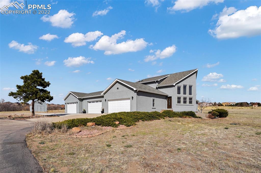 545 Struthers Loop Colorado Springs, CO 80921 - Photo 9 of 44 a front view of a house with a yard