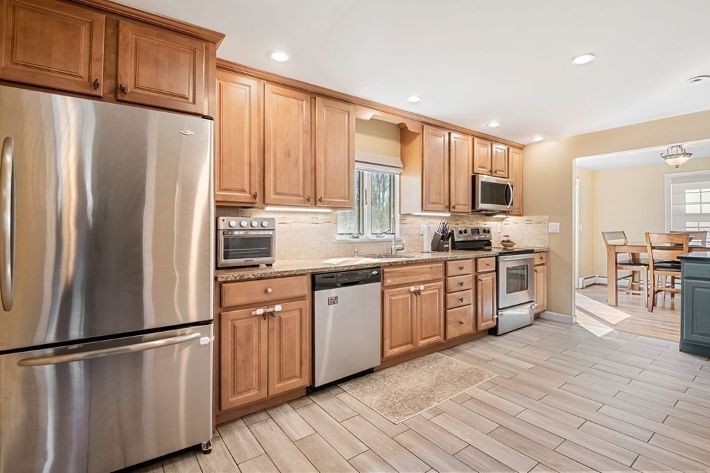 224 Oregon Road Ashland, MA 01721 - Photo 2 of 15 a kitchen with stainless steel appliances granite countertop a refrigerator stove microwave and sink