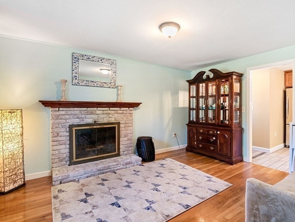224 Oregon Road Ashland, MA 01721 - Photo 5 of 15 a living room with furniture and a fireplace