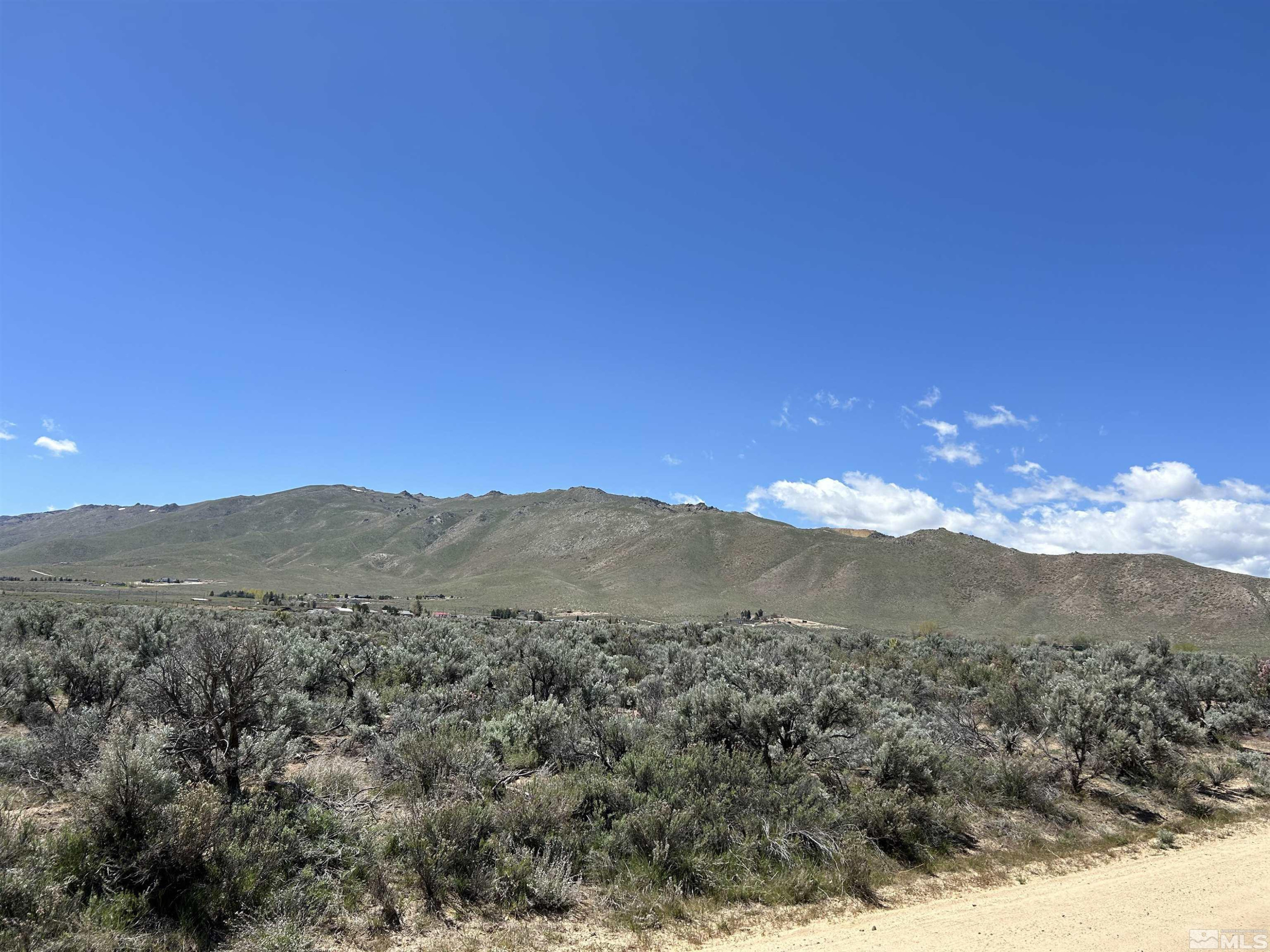 22905 Fetlock Drive Reno, NV 89508 - Photo 11 of 18 a view of a mountain range in a cloudy sky