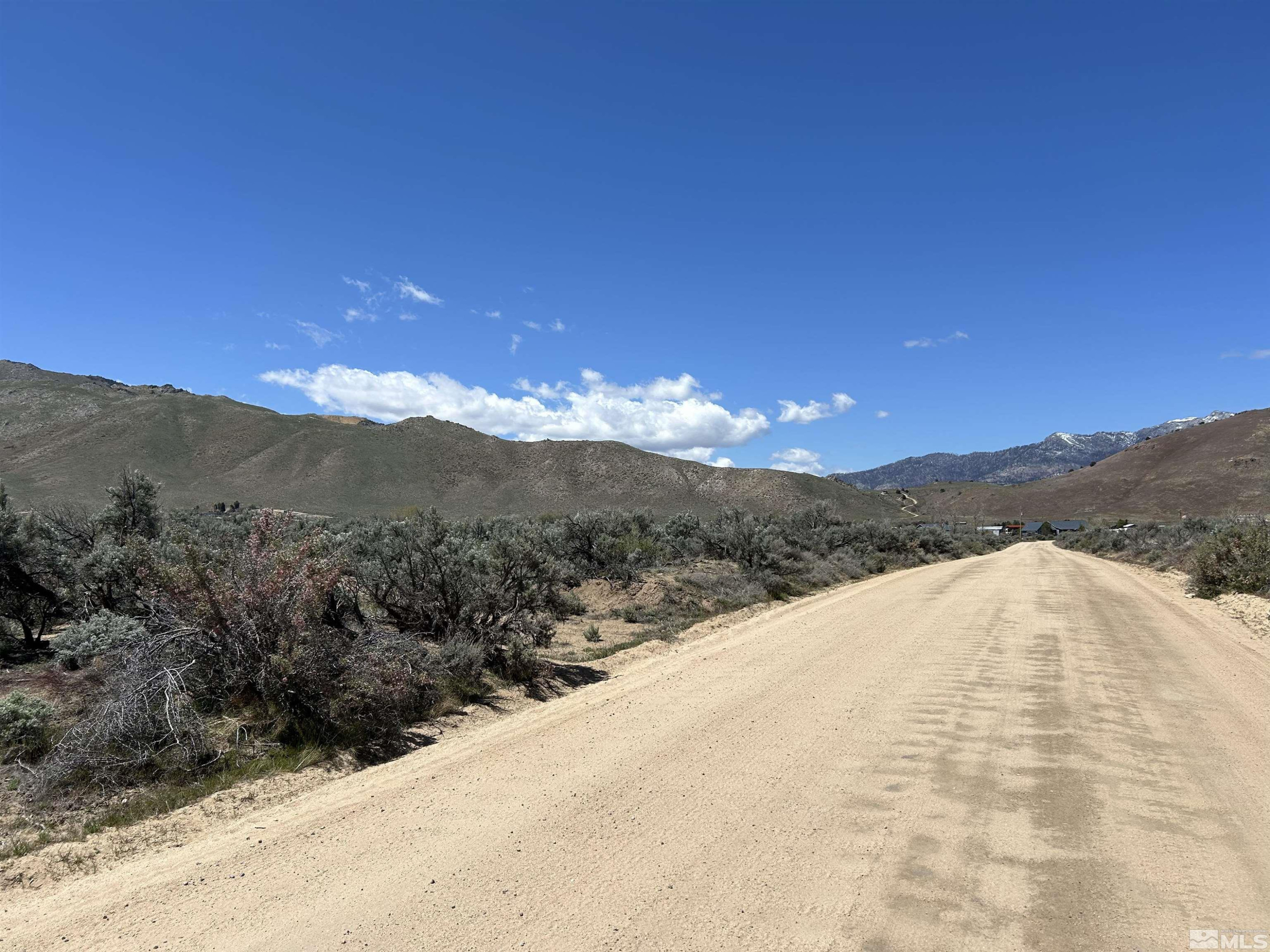22905 Fetlock Drive Reno, NV 89508 - Photo 6 of 18 a view of a dry yard with mountains in the background