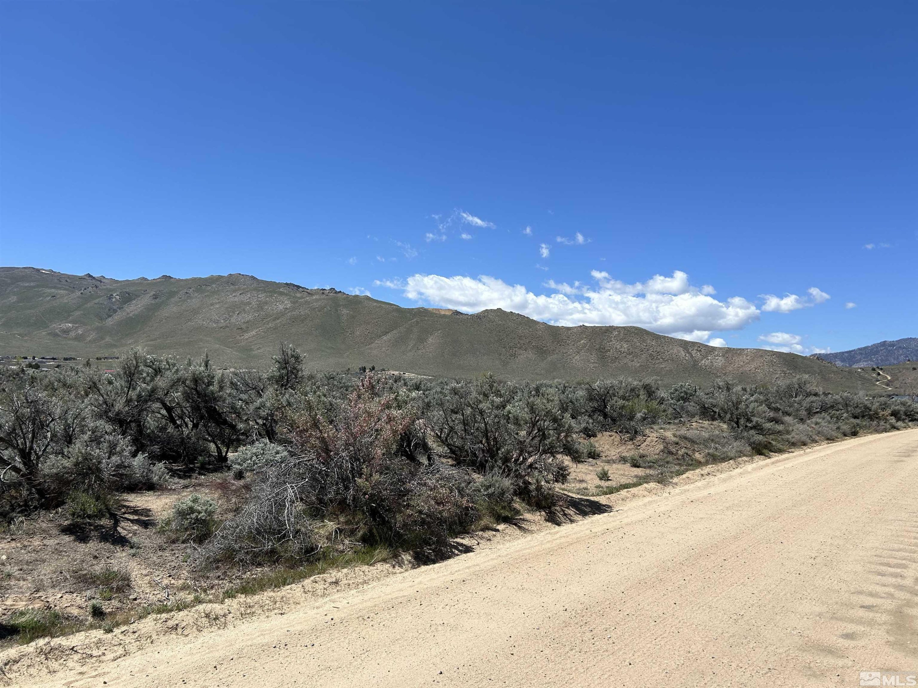 22905 Fetlock Drive Reno, NV 89508 - Photo 7 of 18 a view of a mountain range in a cloudy sky