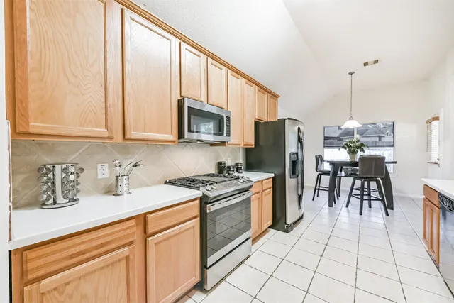 a kitchen with stainless steel appliances a refrigerator and a sink