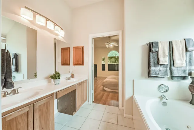 a bedroom with a bed dresser and a flat tv screen