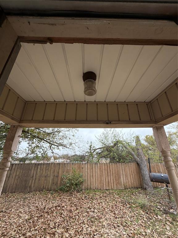 400 South Vick Street Decatur, TX 76234 - Photo 11 of 22 a black and white view of backyard with wooden fence