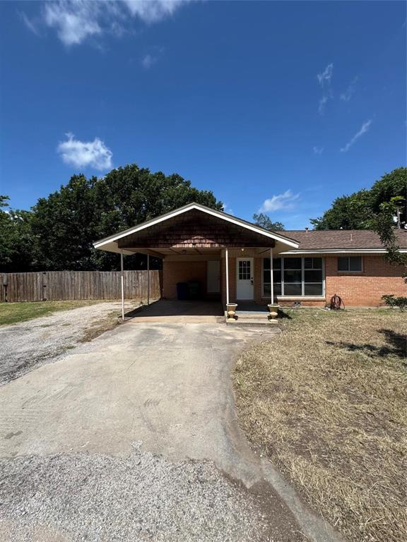 400 South Vick Street Decatur, TX 76234 - Photo 13 of 22 a front view of a house with a yard and garage