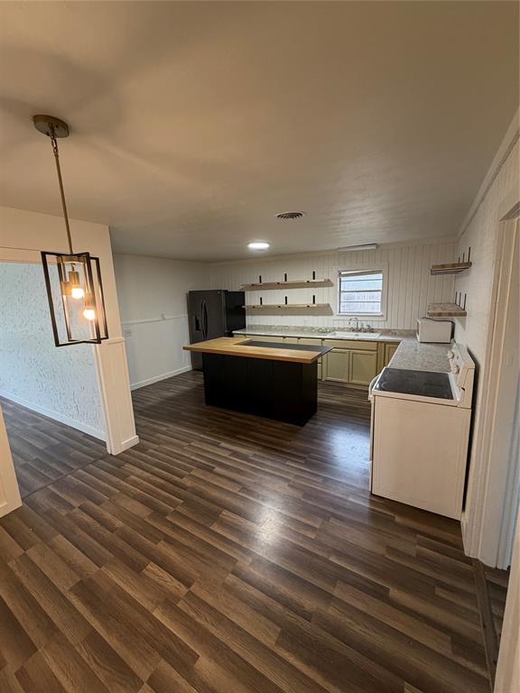 400 South Vick Street Decatur, TX 76234 - Photo 3 of 22 a kitchen with stainless steel appliances granite countertop a sink stove and wooden floor