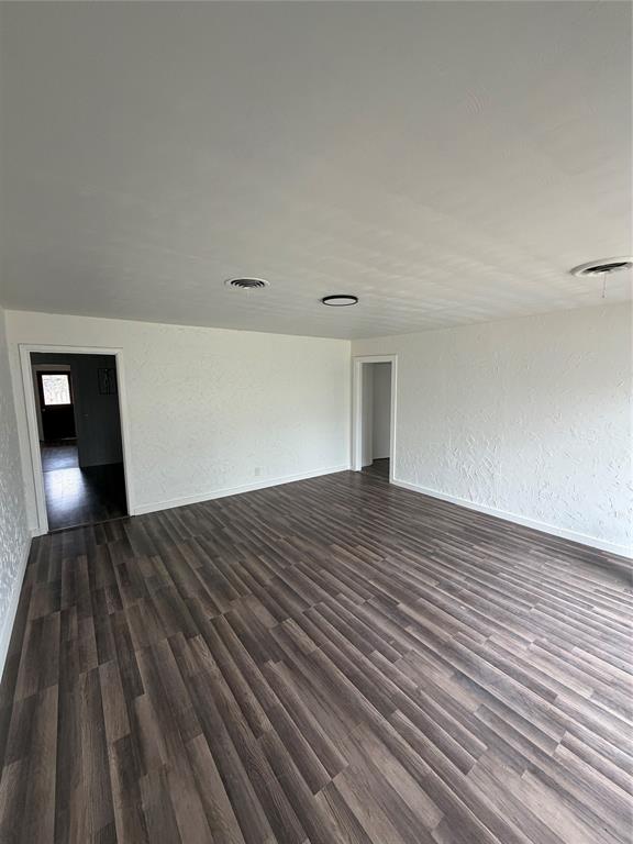 400 South Vick Street Decatur, TX 76234 - Photo 5 of 22 a view of empty room with wooden floor