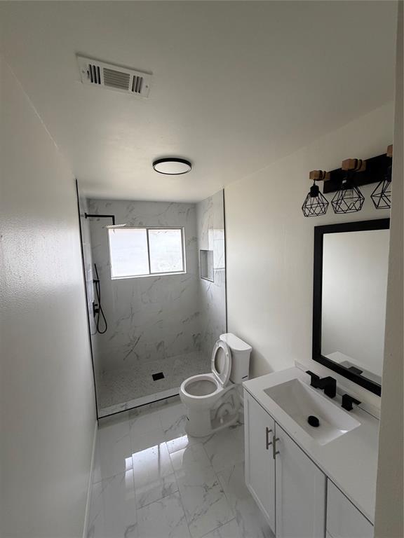 400 South Vick Street Decatur, TX 76234 - Photo 9 of 22 a bathroom with a sink a toilet and shower
