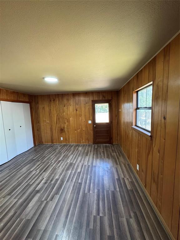 400 South Vick Street Decatur, TX 76234 - Photo 10 of 22 a view of an empty room with wooden floor and a window