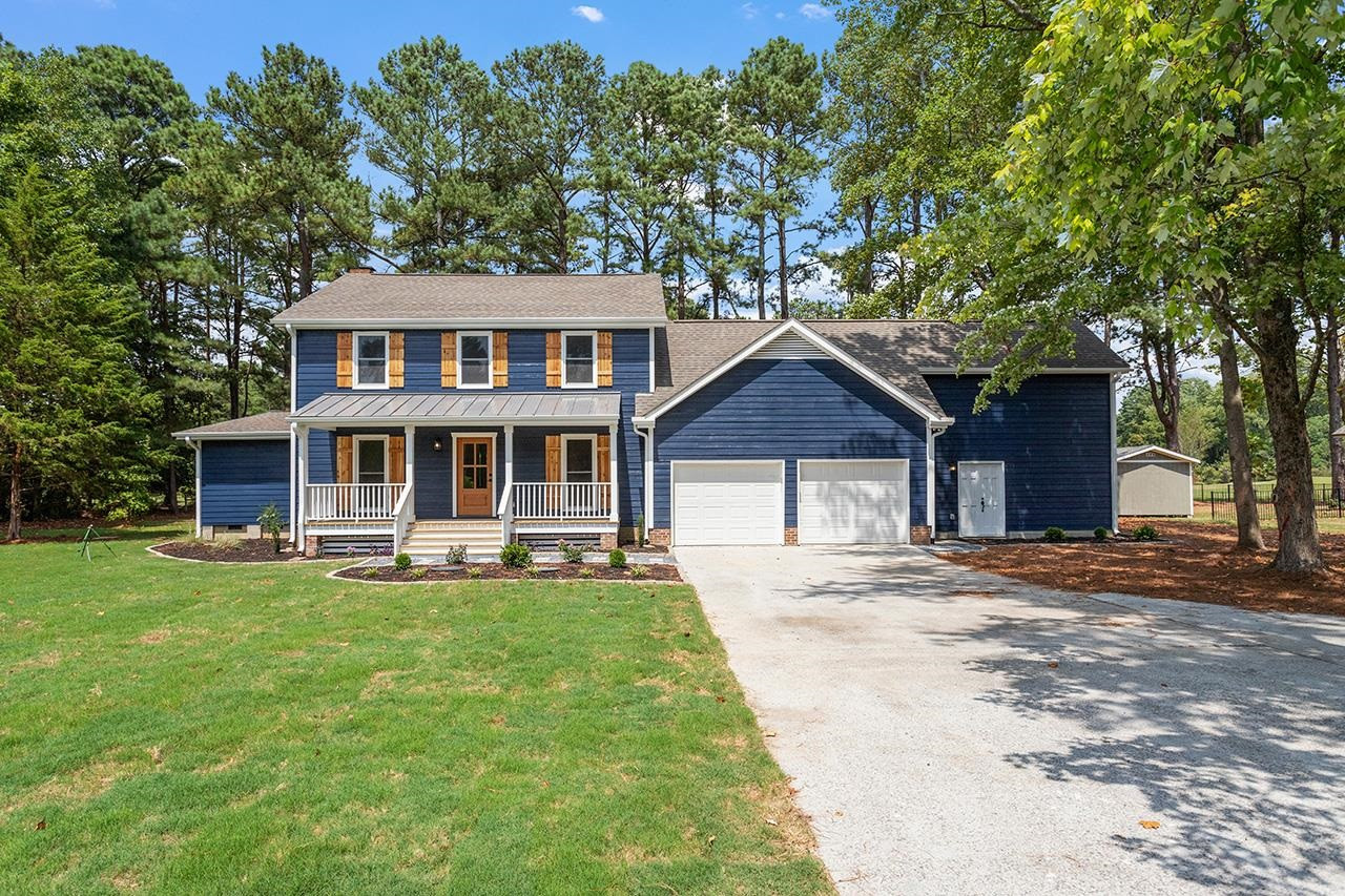 a front view of a house with a garden