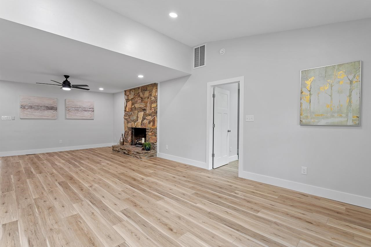 3420 East Garner Road Clayton, NC 27520 - Photo 11 of 30 a view of empty room with wooden floor and window