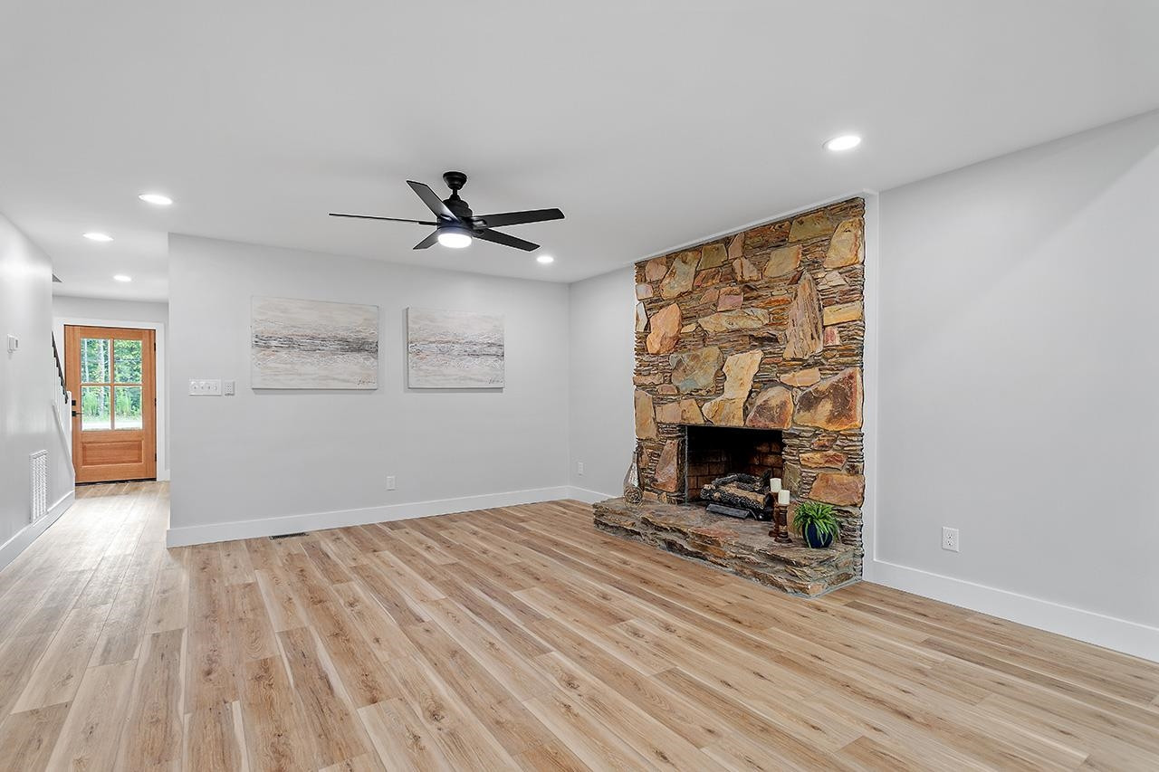 3420 East Garner Road Clayton, NC 27520 - Photo 12 of 30 wooden floor in living room with a fireplace