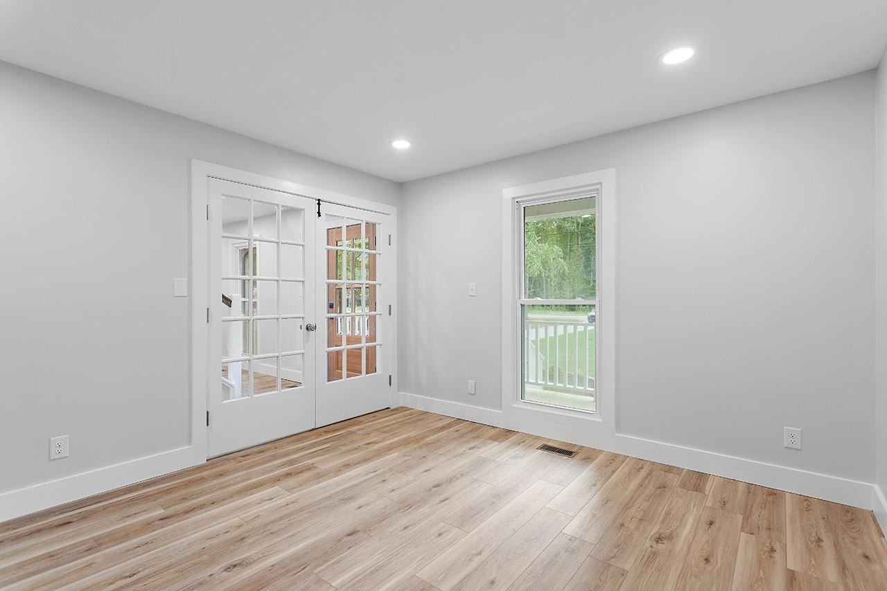 3420 East Garner Road Clayton, NC 27520 - Photo 14 of 30 an empty room with wooden floor and windows