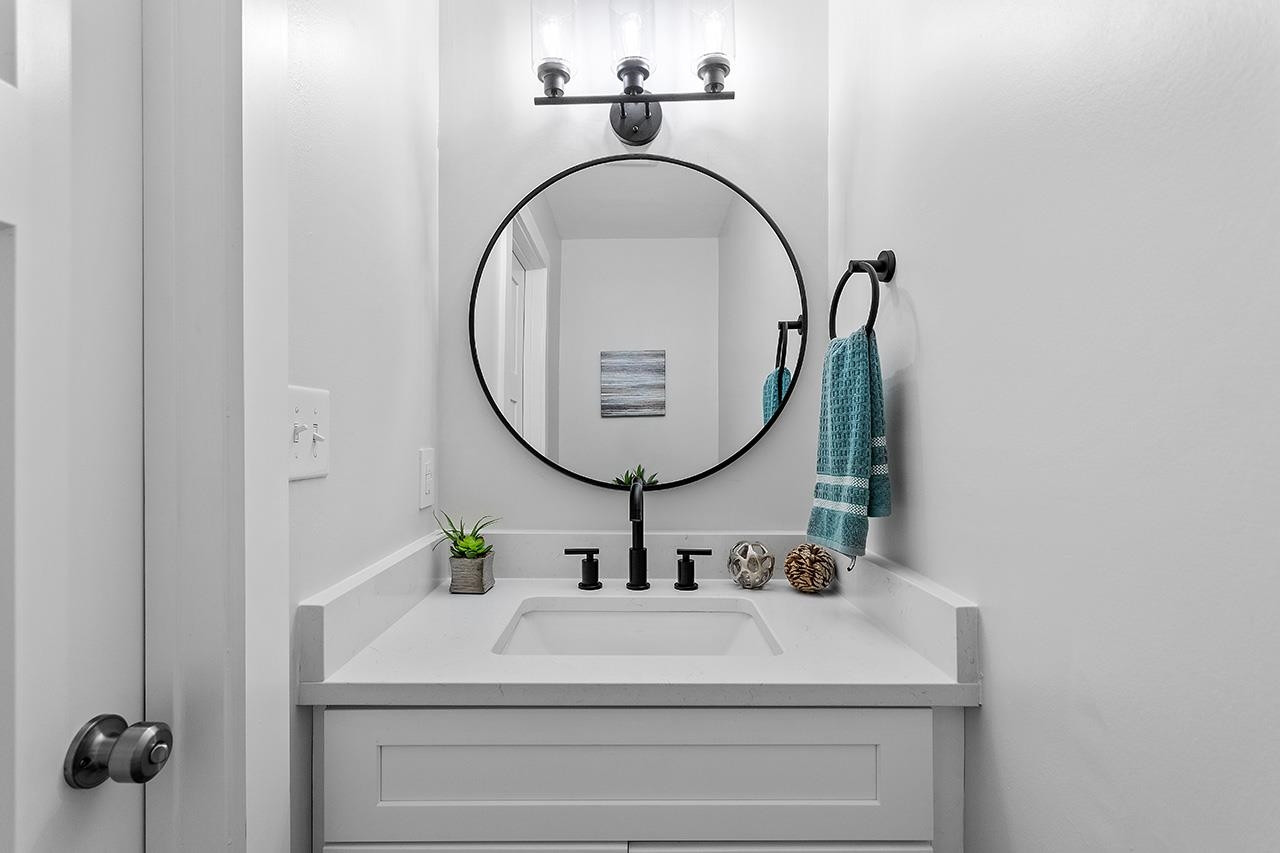 3420 East Garner Road Clayton, NC 27520 - Photo 15 of 30 a bathroom with a sink and a mirror