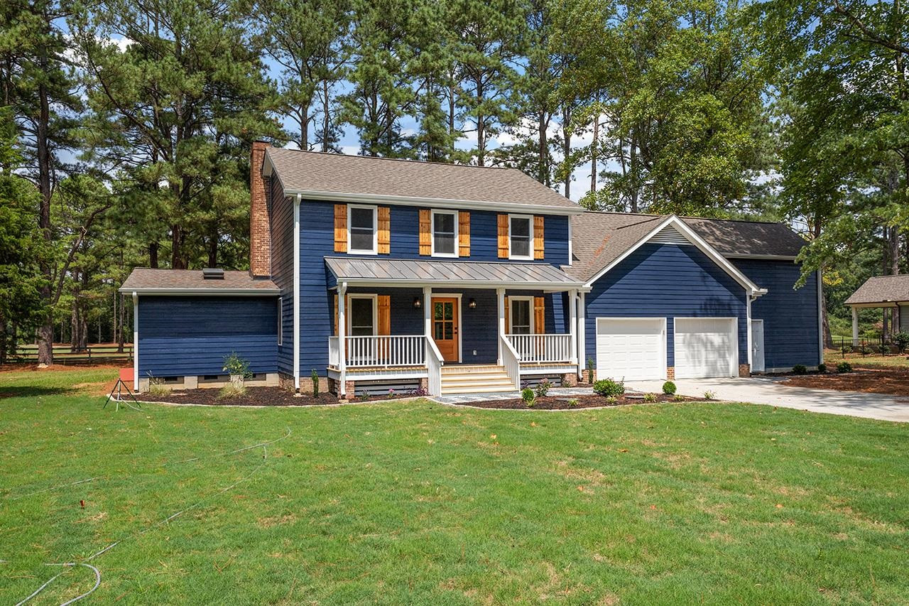3420 East Garner Road Clayton, NC 27520 - Photo 2 of 30 a front view of a house with a yard and trees