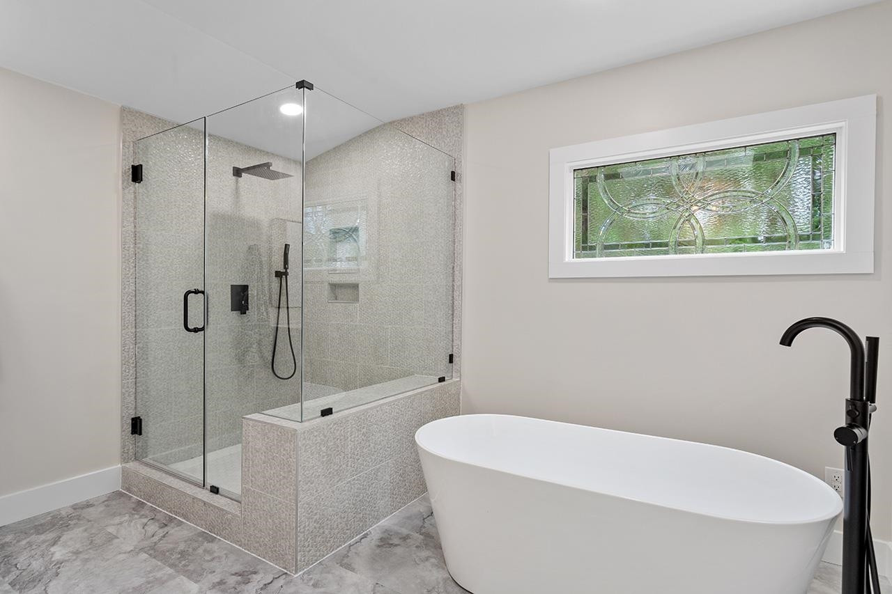 3420 East Garner Road Clayton, NC 27520 - Photo 21 of 30 a white bath tub sitting next to a shower