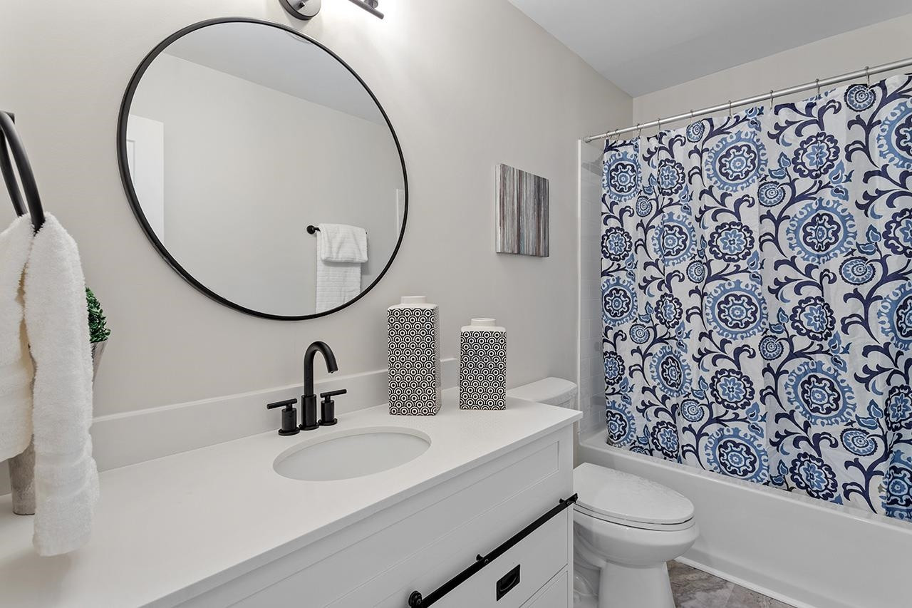 3420 East Garner Road Clayton, NC 27520 - Photo 27 of 30 a bathroom with a sink toilet and a mirror