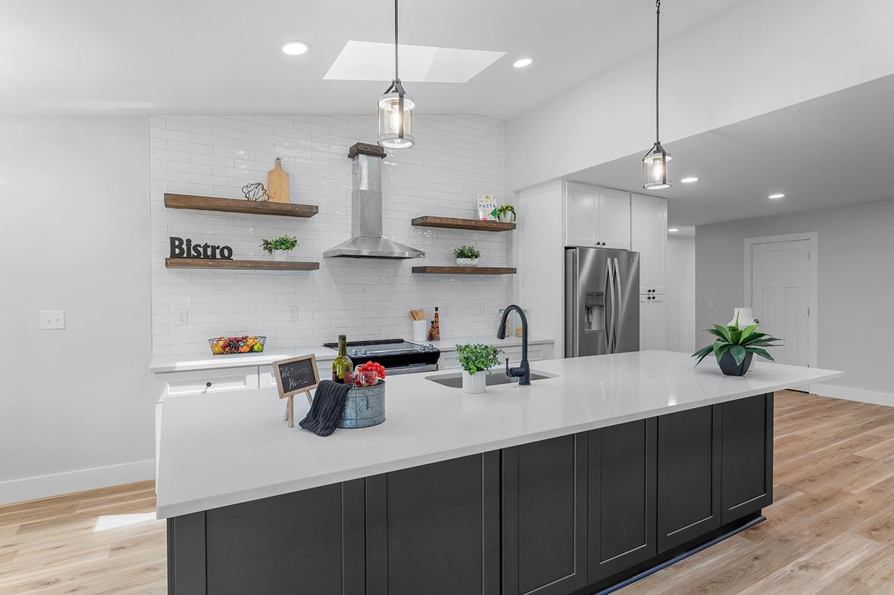 3420 East Garner Road Clayton, NC 27520 - Photo 4 of 30 a kitchen with stainless steel appliances a sink a refrigerator and wooden floor