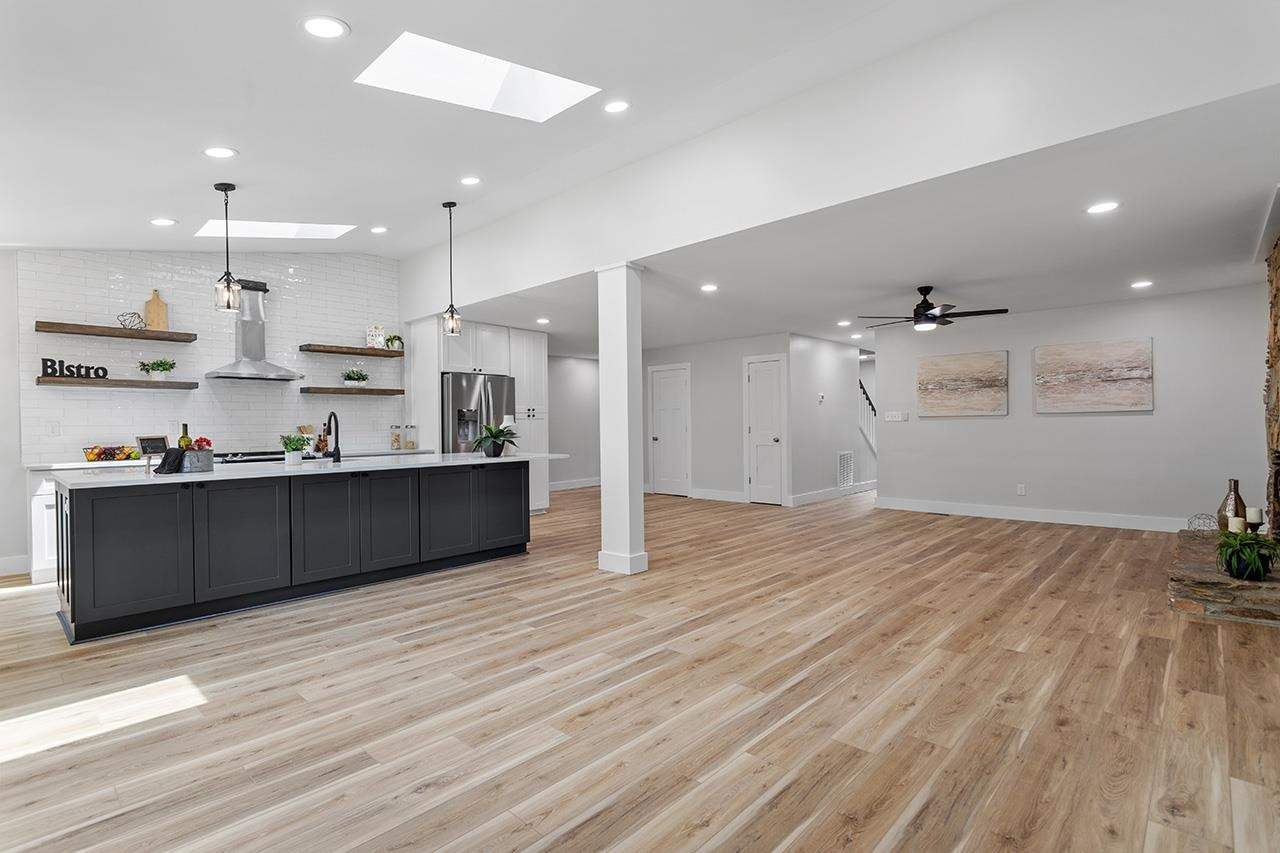 3420 East Garner Road Clayton, NC 27520 - Photo 5 of 30 a large kitchen with stainless steel appliances kitchen island a large counter top and a wooden floors