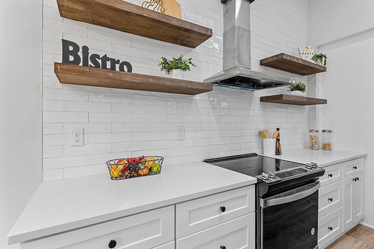 3420 East Garner Road Clayton, NC 27520 - Photo 8 of 30 a kitchen with a stove and cabinets