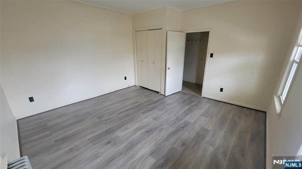 90 Ackerson Street, Unit 1 Hackensack, NJ 07601 - Photo 11 of 14 a view of an empty room with wooden floor