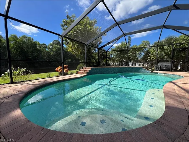 a view of a backyard with sitting area